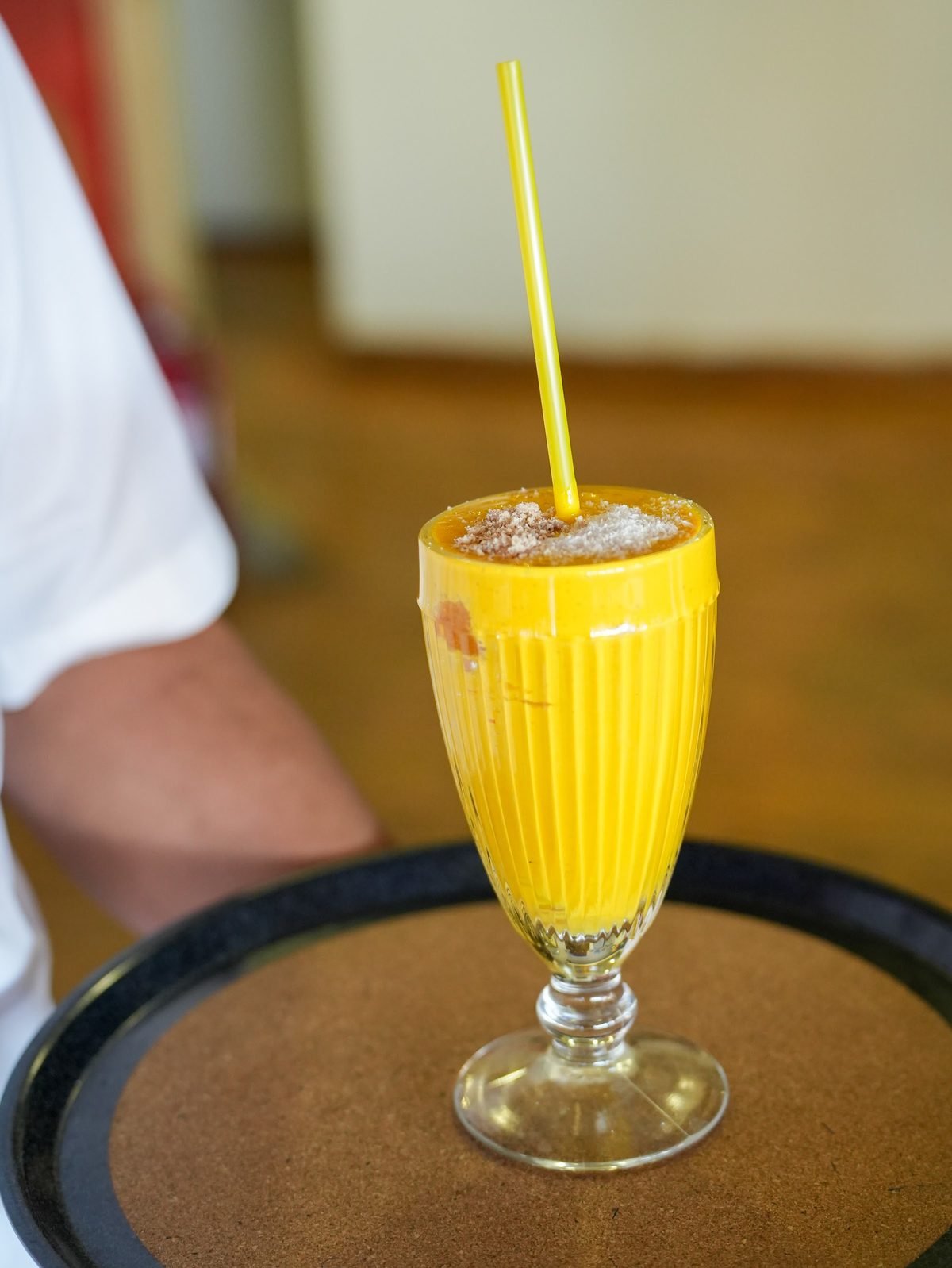 A mango lassi served on a tray