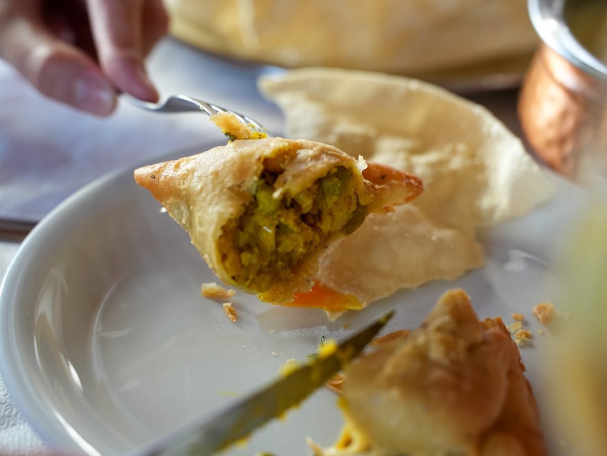 A vegetable samosa cut open